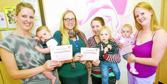 ACHIEVEMENTS . . . Siobhan Thomson and Douglas, peer support volunteer Lois McCloskey, Amy Hoffmann with Jacob and Penny McLatchie with Freya at the Lockerbie drop in