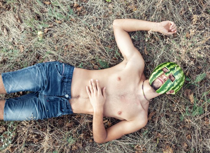 Photo of the young soldier with a water-melon on a head