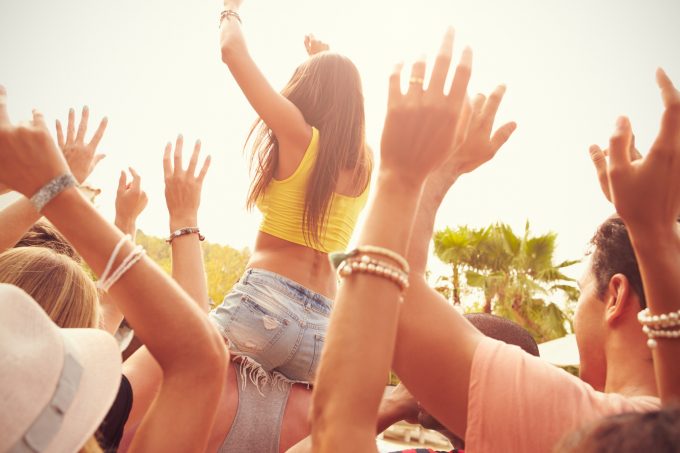 Group Of Young People Enjoying Outdoor Music Festival