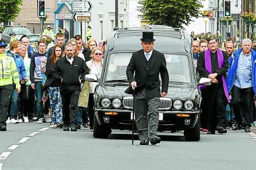 Mourners line streets for Mikey