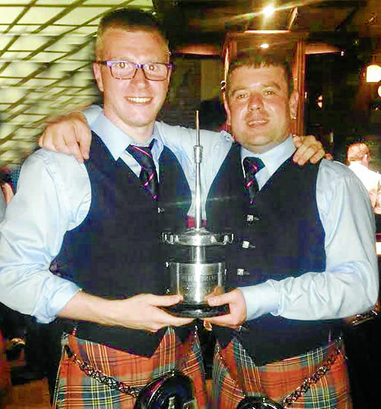 Piping pair help band to world victory