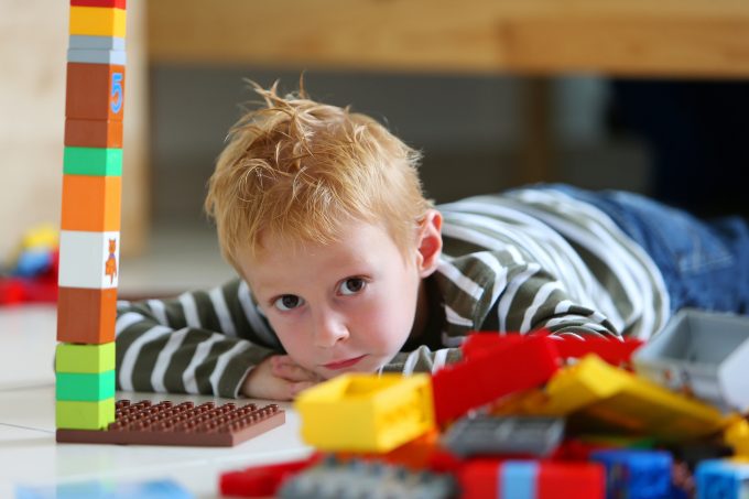 Boy playing with colored bricks