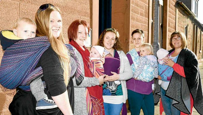 STEPPING OUT . . . Annan mums hit the streets to mark International Babywearing Week. The event was organised by Slinging Around Dumfries and Galloway to raise awareness of carrying babies and tots in slings. The group also enjoyed refreshments at Aberlour and are holding a fundraising raffle. Left to right: Emma Dinnin and Ralph, Heather Kirk and Dharcie, Jade Greiner and Leila, Louise Ross and Iona-Marie, Sarah Vickers and Bryony