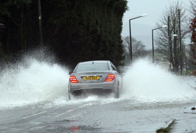 SPLASH . . . water on the A711 this morning