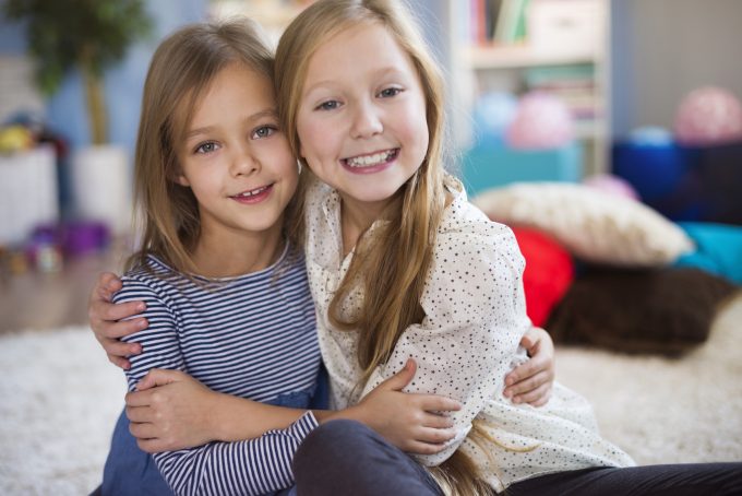 Portrait of charming blonde sisters