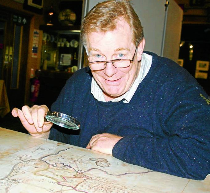 CLOSE INSPECTION . . . project member Archie McConnel with one of the original 18th century maps on display in the exhibition at Dumfries Museum
