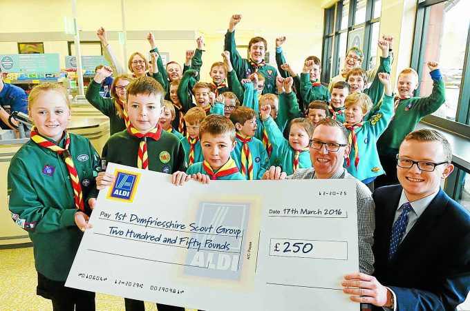CHEQUE CHEER . . . 1st Dumfriesshire Scout Group receive a cheque for £250 from Aldi *** Local Caption *** CHEQUE CHEER . . . 1st Dumfriesshire Scout Group receive a cheque for £250 from Aldi