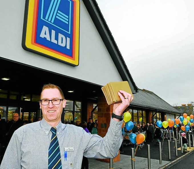 GOLDEN BOY . . . Aldi Annan manager Lee Richardson showing off the golden tickets