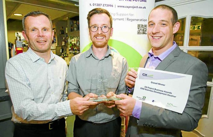 John Grierson, Chapelcross Closure Director, presenting awards for Best Employer and Overall Winner to Creatomatic (Kit Allen, James Miodonski) *** Local Caption *** DOUBLE DELIGHT . . . John Grierson, of Magnox, presenting awards for Best Employer and Overall Winner to Creatomatic's Kit Allen, centre, and James Miodonski, right