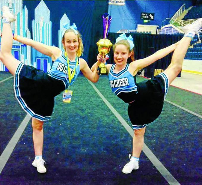 MAGIC MOVES . . . Atlanta Mason and Ami Barber-Fleming  of DG Cheer celebrate after the squad's first major cheerleading win