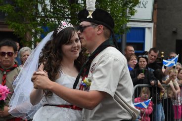 Scout leaders tie the knot . . .with a little help from their troop