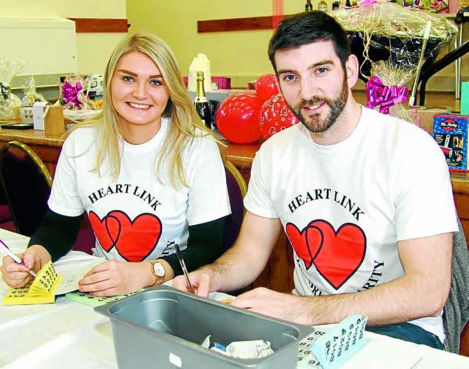 RAFFLE TIME . . . smiles from Nicola Robertson and Craig Murdoch as the raffle money rolls in *** Local Caption *** RAFFLE TIME . . . smiles from Nicola Robertson and Craig Murdoch as the raffle money rolls in