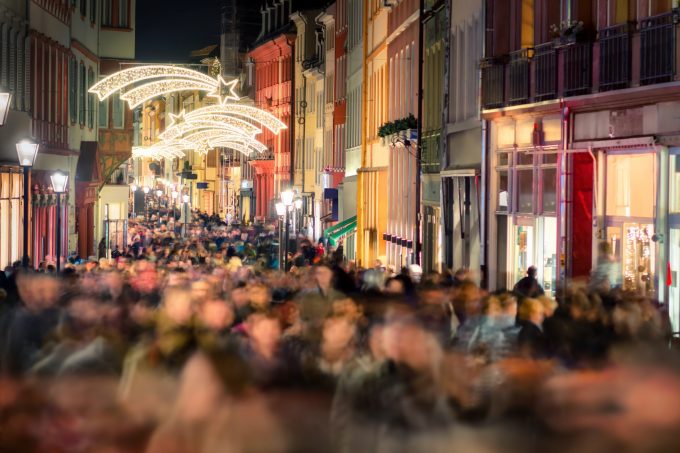 Large crowd of people hustling and shopping in a pedestrian area in Heidelberg, Germany, for Christmas