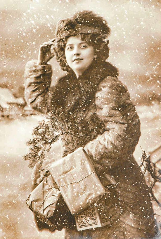 Young woman with christmas tree and gifts. Vintage picture