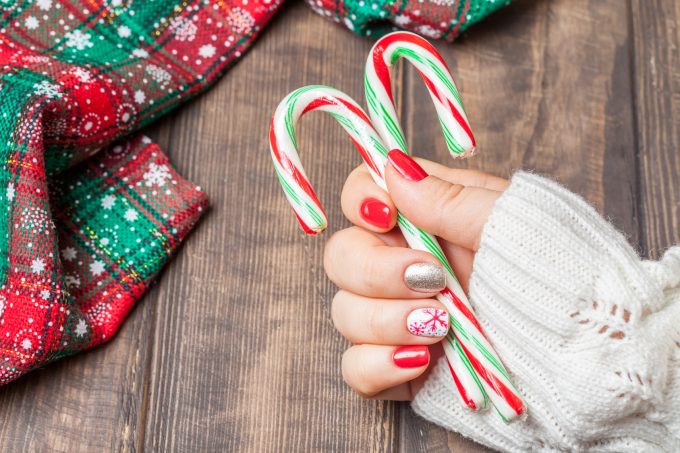 Christmas Nail art manicure. Winter Holiday style bright Manicure with gems Christmas tree and snowflakes