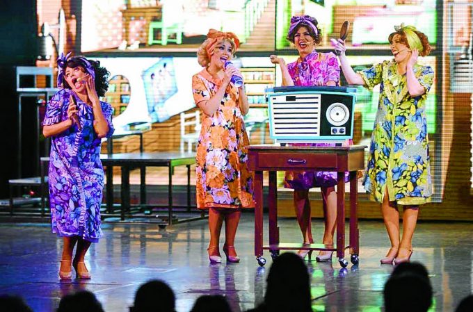 GIRL GROUP . . . performing with other cast members on the ship