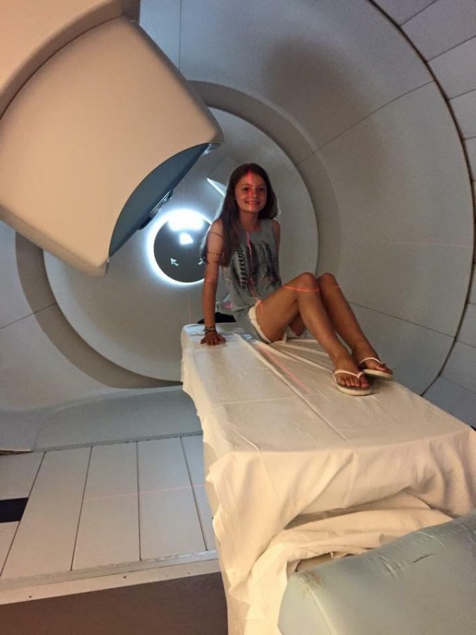 Eilidh on the proton beam therapy machine