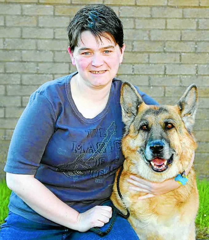 UNITED . . . Susan Wright of Dumfries is grateful to the fire and rescue team who came to the rescue of her pet German Shepherd Sabre