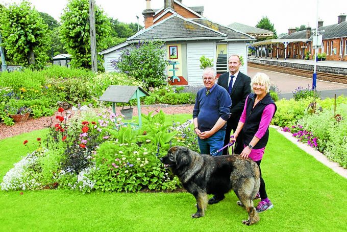 BEAUTIFUL GARDEN . . . left to right: Louis Wall from the South West Railway Adopters Gardening Group in the station garden at Dumfries Railway Station on Wednesday with Mark Jardine from The People's Project and artist Jo McSkimming
