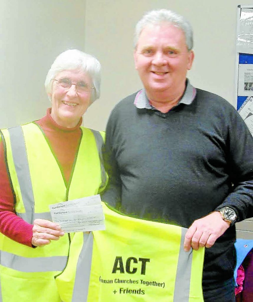 LITTER FUND . . . chairman of Annan Community Council, Allan Weild, is pictured presenting Heather Pail of the All Churches Together and friends group with a cheque for £150. This group was started when a group of people went out for a walk and noticed the litter around the town, and decided to do something to stop the problem. The money is used to buy equipment to assist in the clean up process.