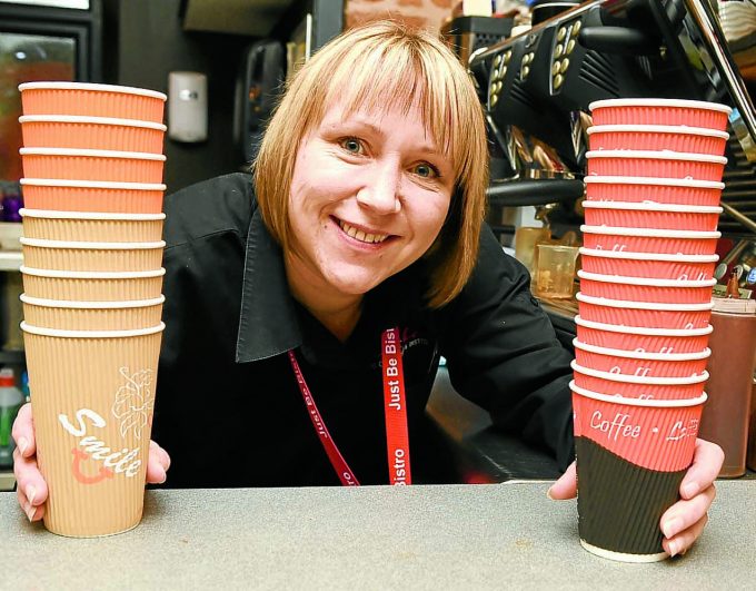 coffee just be *** Local Caption *** LATTE LEVY . . . Vikki Kerr with some of the disposable coffee cups at Just Be