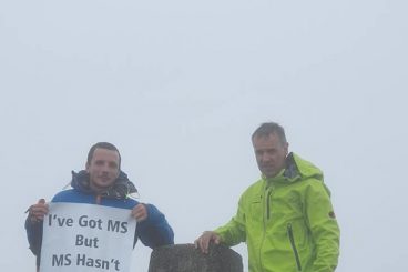 Adam is on top of the world after peak challenge