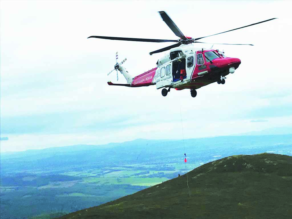 Walker in hill helicopter rescue